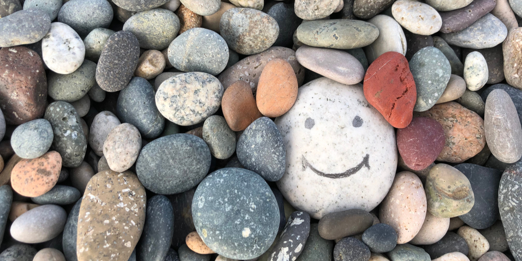 Pile of rocks with a smiling face drawn on one