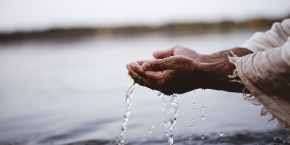 Hands cupping water